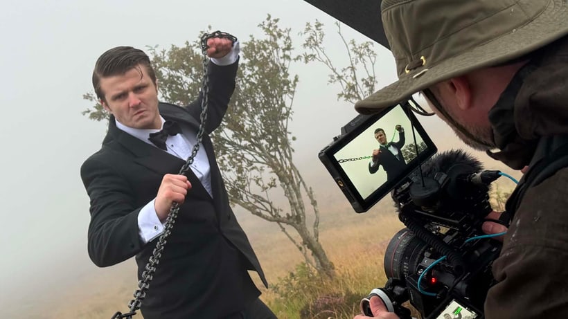 Callum Alexander Wright holds a chain as the camera crew films a scene for Place of Execution